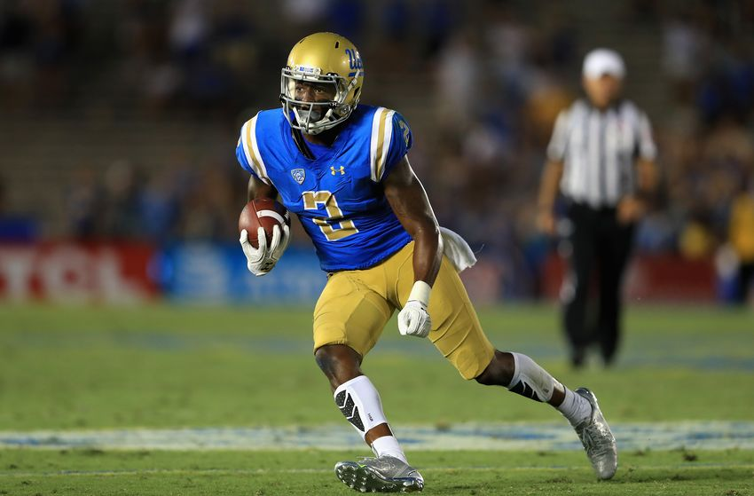 Jordan Lasley runs with the football for UCLA.